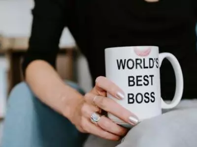 Woman holding World's Best Boss mug